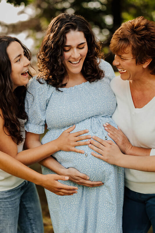 Mother daughter and grandmother laughing together during maternity and family photography session West Michigan GAUPERfamilies