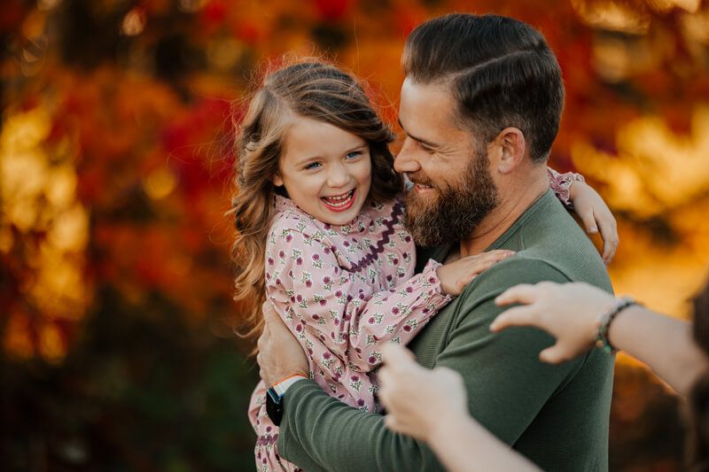 The Gauper family laughing together during a golden hour session West Michigan GAUPERfamilies